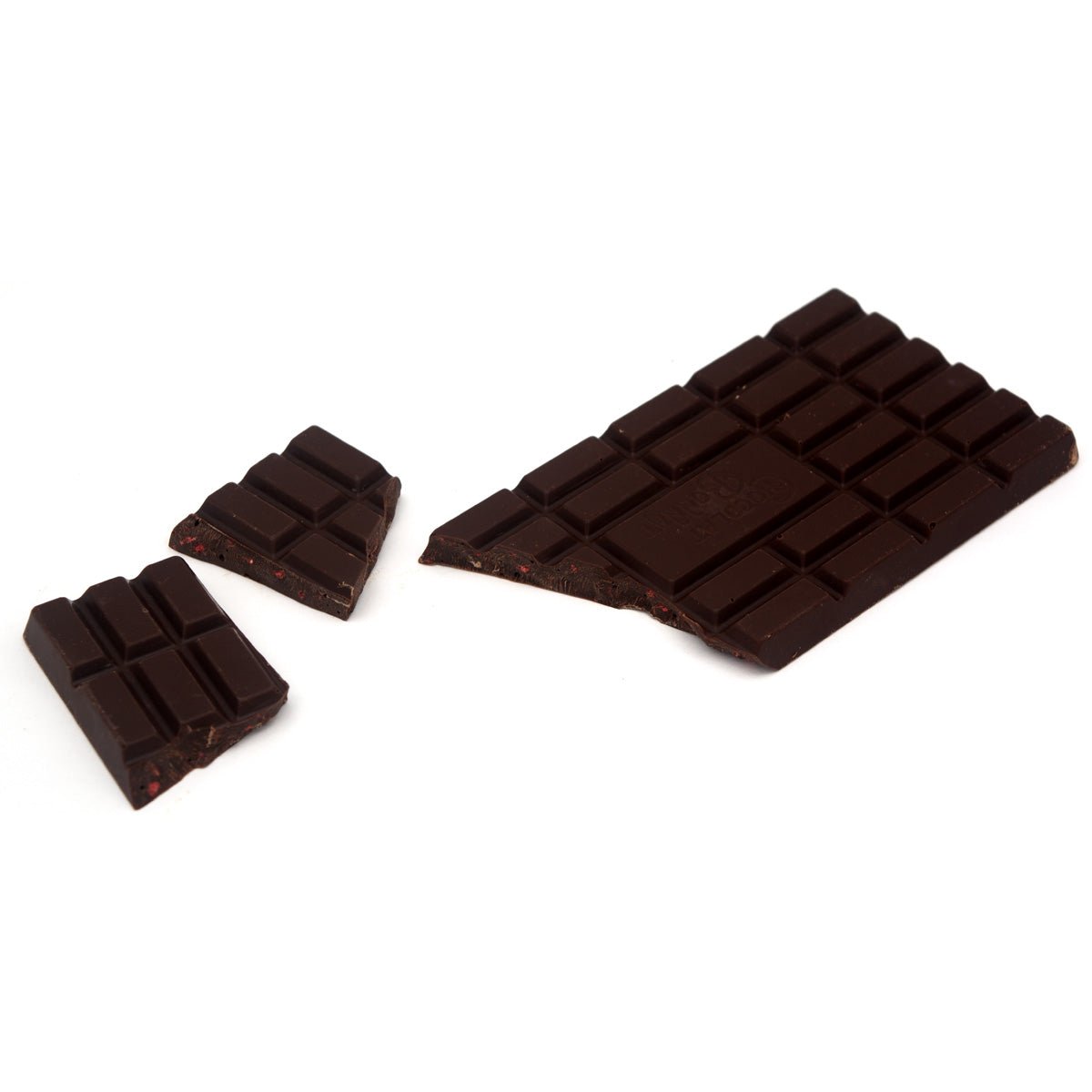 Dark chocolate bar with a few pieces broken off on a white background