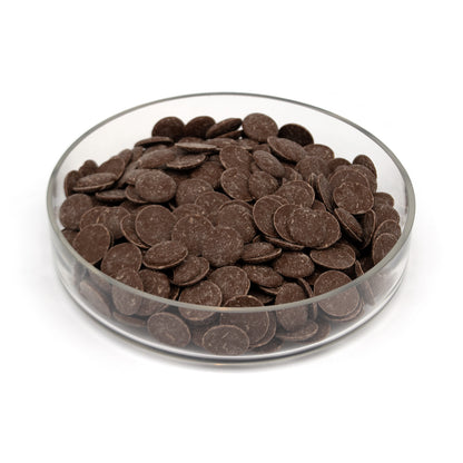 Glass bowl half filled with chocolate wafers on a white background
