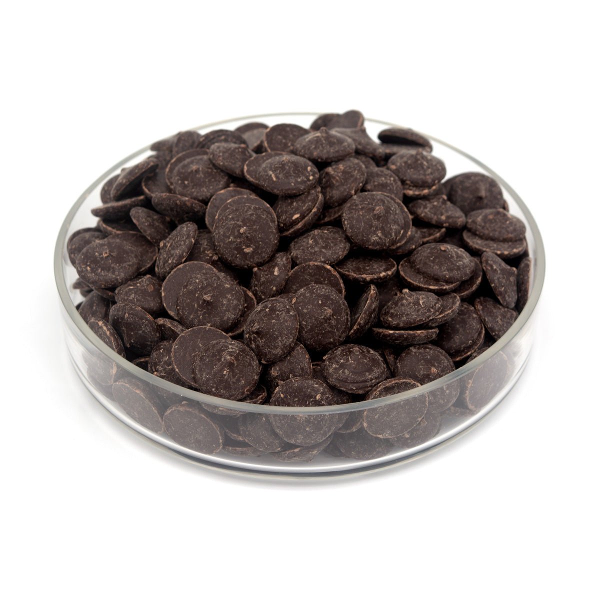 Glass bowl filled with dark chocolate wafers on a white background