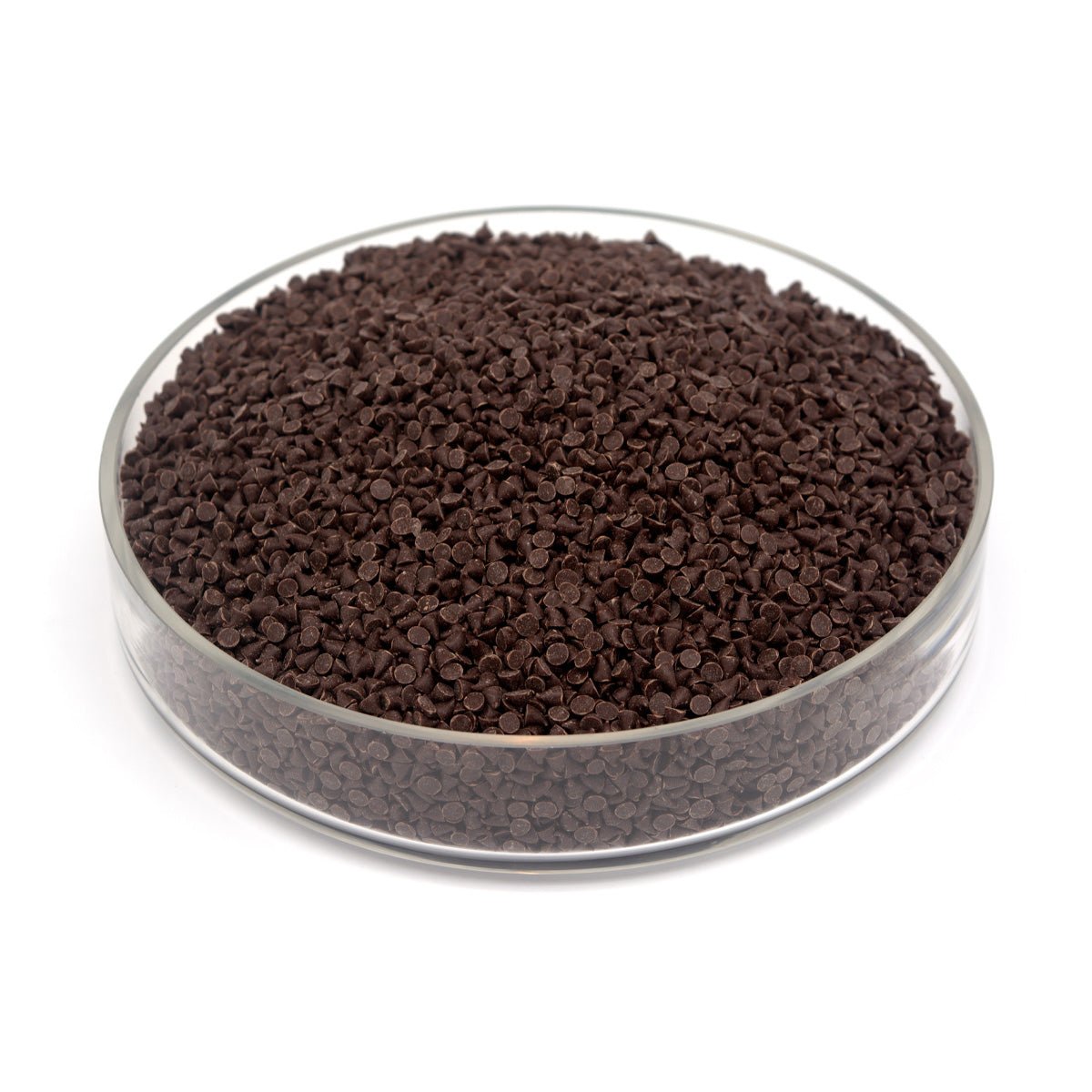 Brown small chocolate chips in a clear glass container on a white background