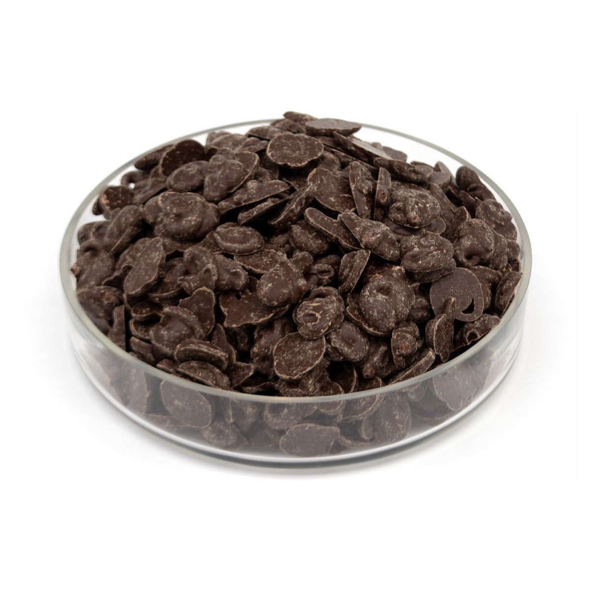 Dark chocolate melts piled in a clear glass bowl on a white background.