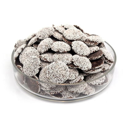 Glass bowl filled with chocolate pieces on a white background