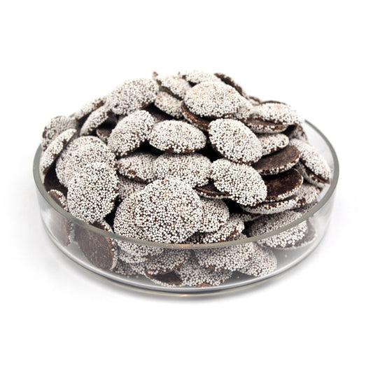 Glass bowl filled with chocolate pieces on a white background