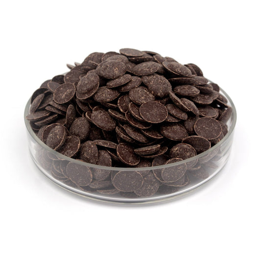 Glass container filled with dark chocolate wafers on a white background