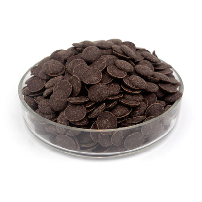 Glass container filled with dark chocolate wafers on a white background
