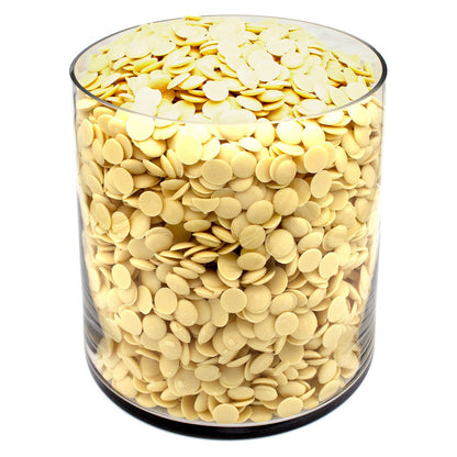 Clear glass container filled with yellow wax melts on a white background