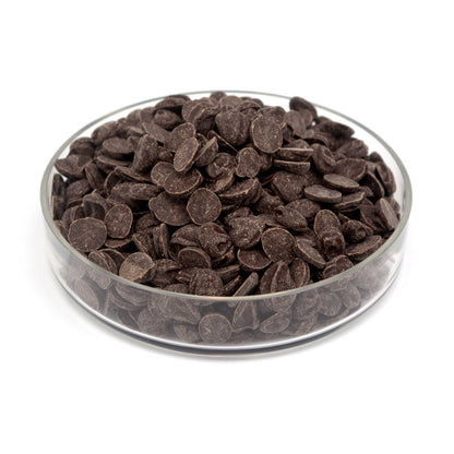 Glass bowl filled with dark chocolate chunks on a white background