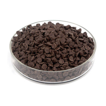Glass bowl filled with chocolate chips on a white background