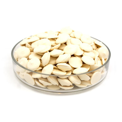 Glass bowl filled with discs on a white background