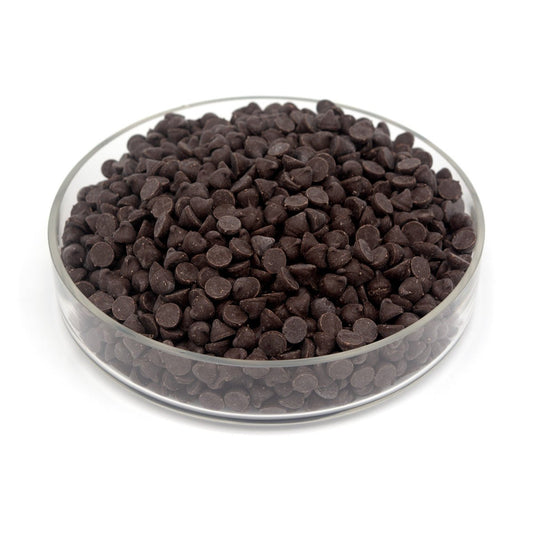 Glass bowl filled with chocolate chips on a white background