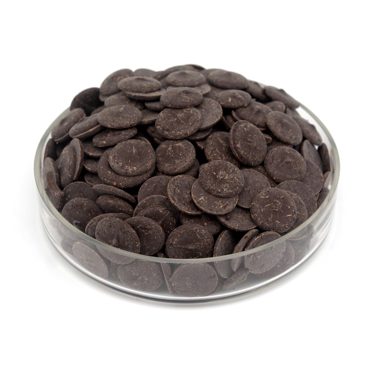 Glass bowl filled with dark chocolate wafers on a white background