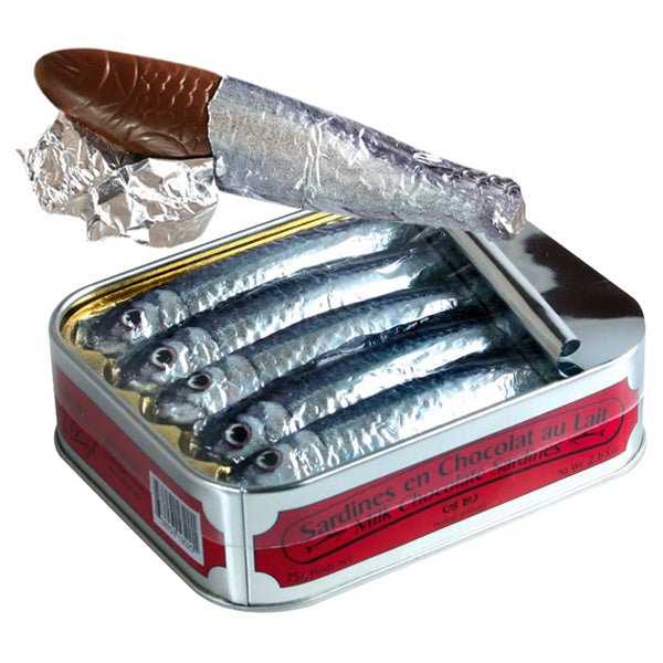 Tin of milk chocolate sardines with one partially unwrapped on a white background