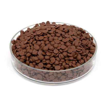 Glass bowl filled with chocolate chips on a white background