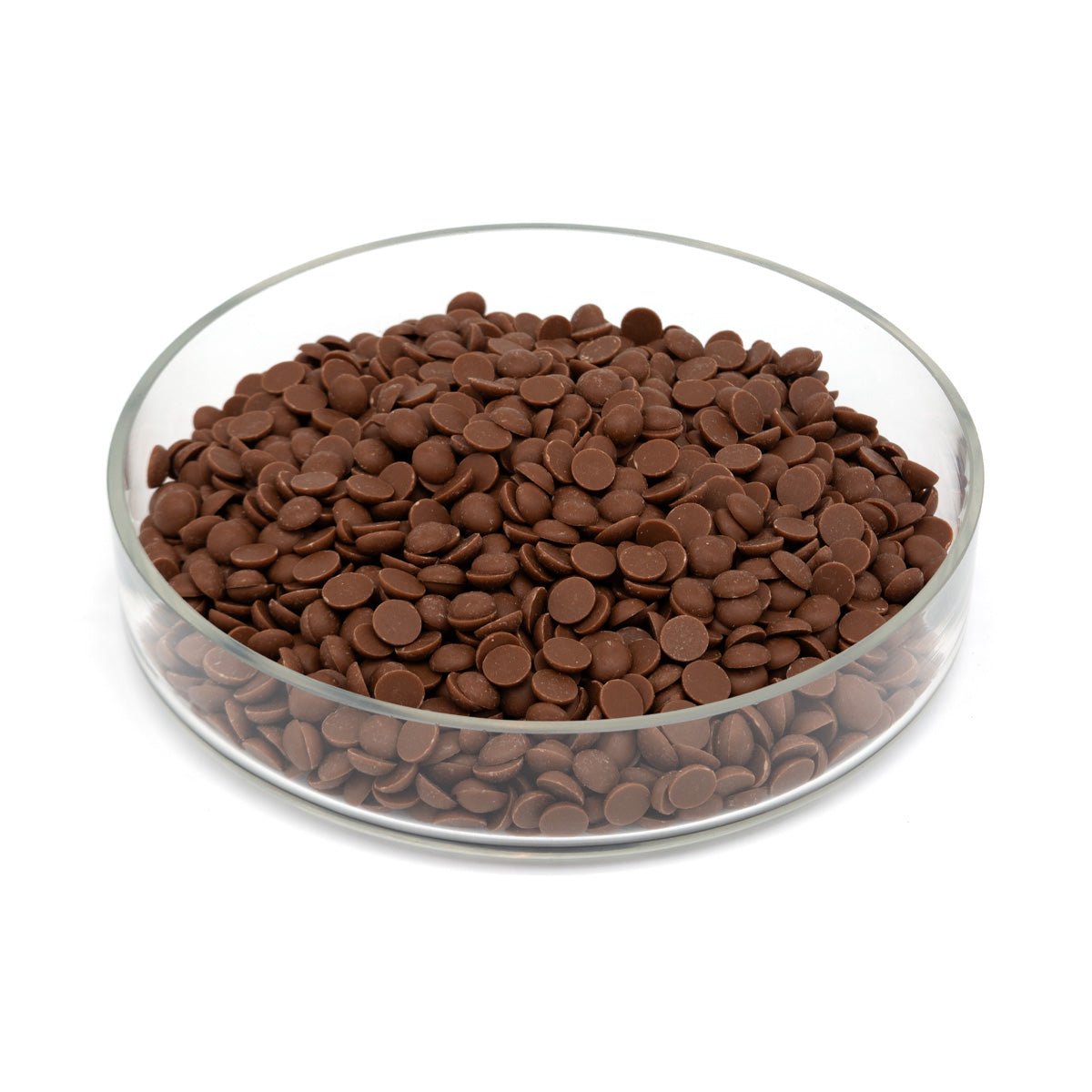 Glass bowl half filled with chocolate chips on a white background
