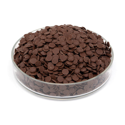 Glass bowl filled with brown chocolate chips on a white background