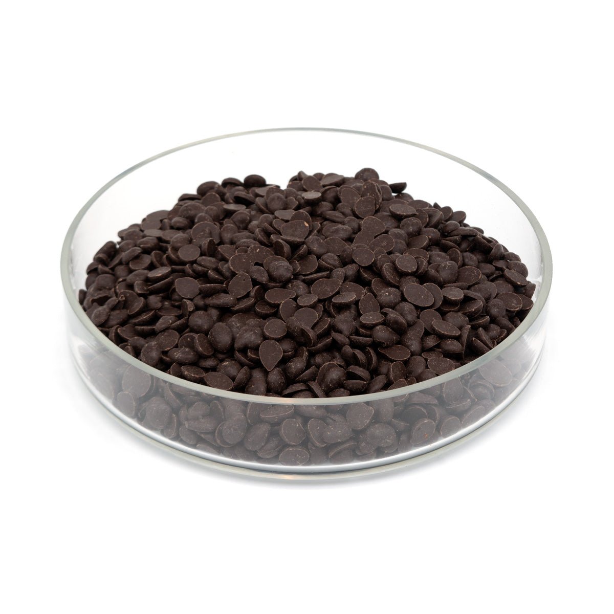 Glass bowl filled with dark chocolate discs on a white background