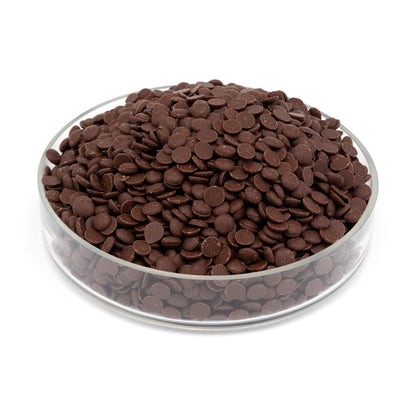 Glass bowl filled with chocolate drops on a white background