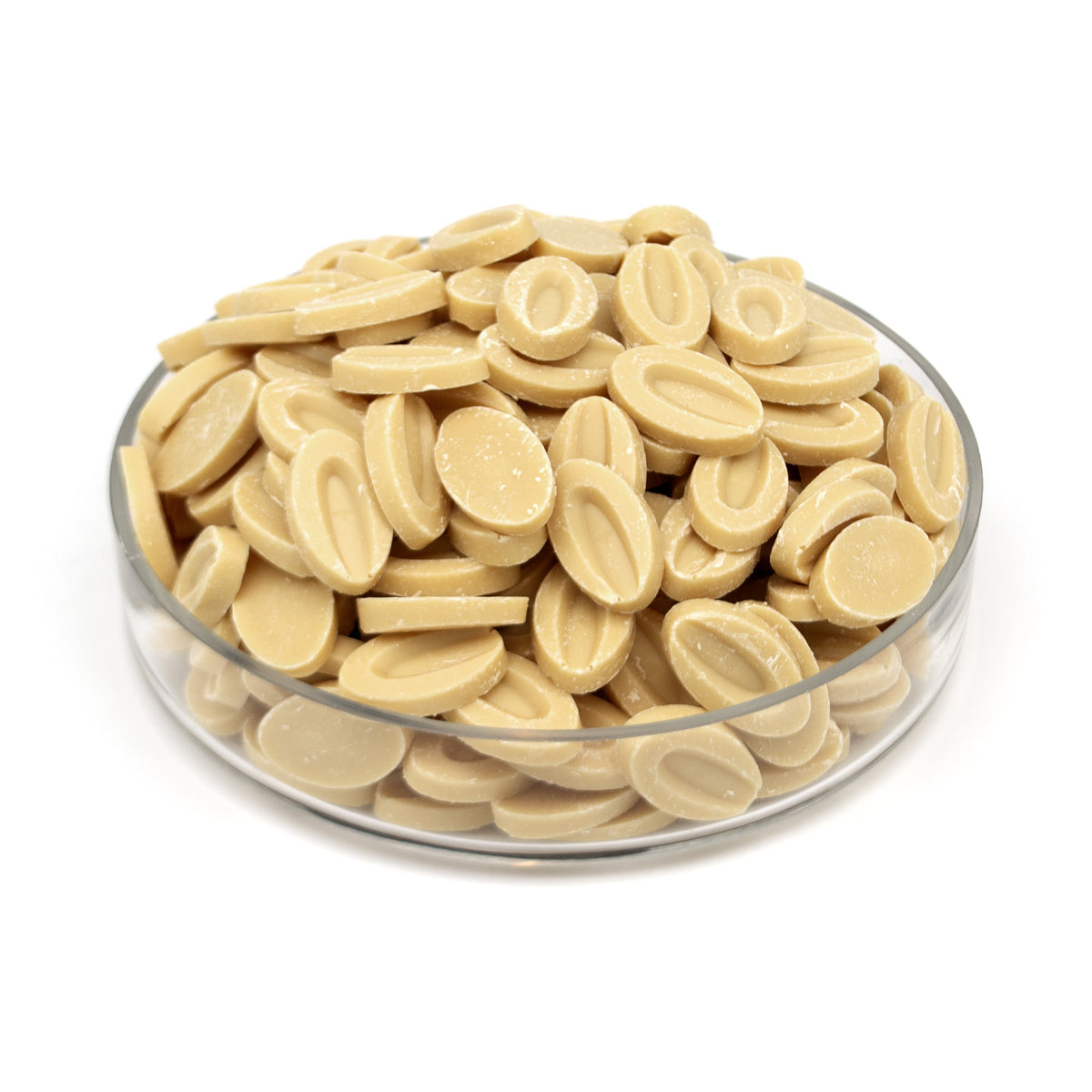 A pile of small oval chocolate discs piled in a clear round glass dish on a white background.