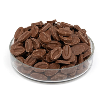Glass bowl filled with chocolate chips on a white background