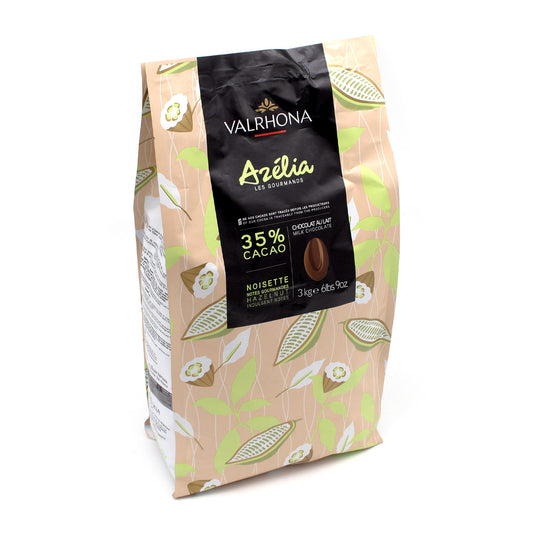 A 3 kg bag of Valrhona Azelia chocolate cacao noisette, featuring a beige and green patterned design with a prominent black label on the front.