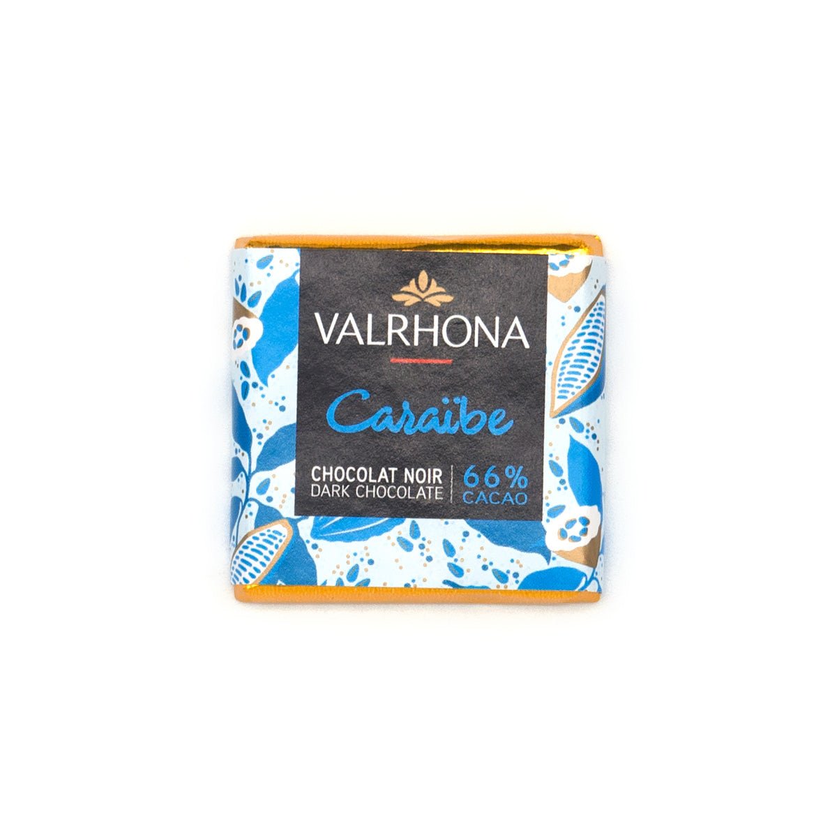 A Valrhona Caraibe dark chocolate napolitain in its wrapper, featuring a black center label with blue and gold accents and a blue-and-white patterned border, set against a plain white background.