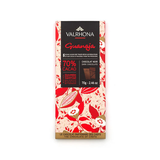 Valrhona Guanaja dark chocolate bar packaging with red and beige design on a white background
