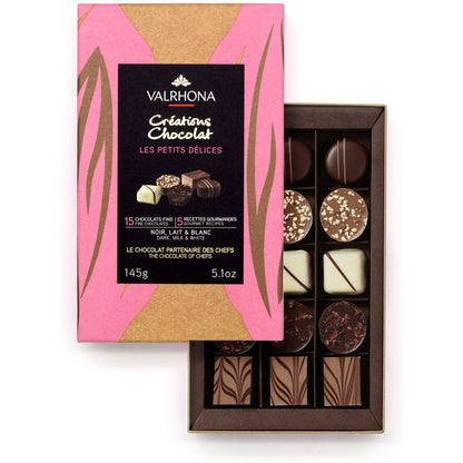 Valrhona chocolate assortment with pink and gold packaging on a white background