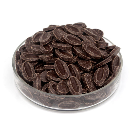 Glass bowl filled with chocolate feves on a white background
