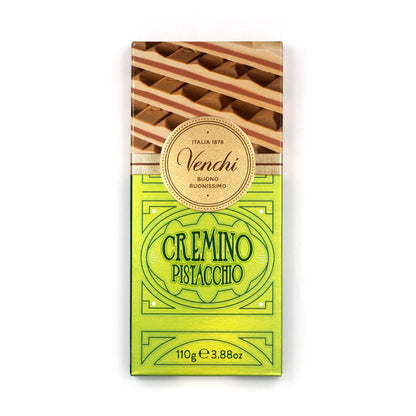 A single bar of Venchi Cremino Pistacchio chocolate in its original packaging, featuring a bright yellow-green lower half with green text and a top section showing striped pistachio layers, on a plain white background.