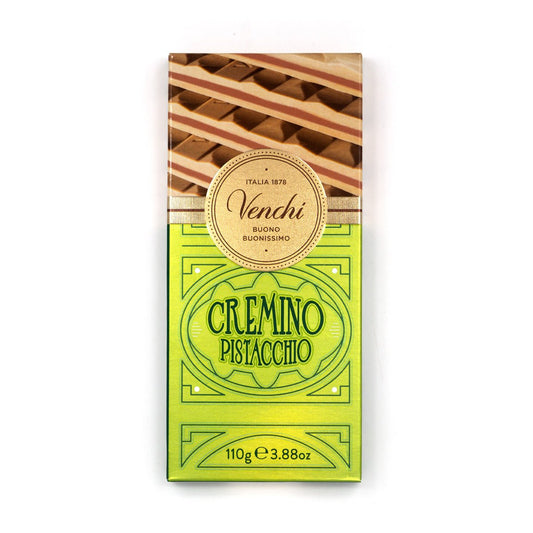 A single bar of Venchi Cremino Pistacchio chocolate in its original packaging, featuring a bright yellow-green lower half with green text and a top section showing striped pistachio layers, on a plain white background.