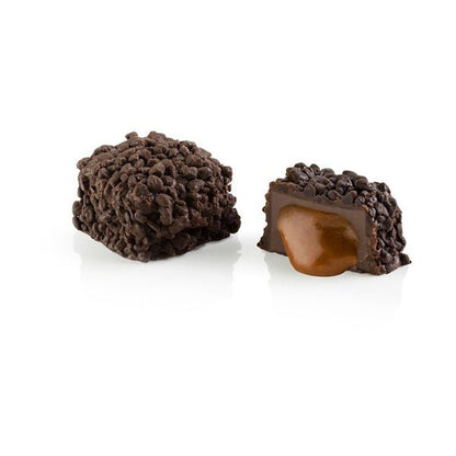 Chocolate truffle with caramel center on a white background