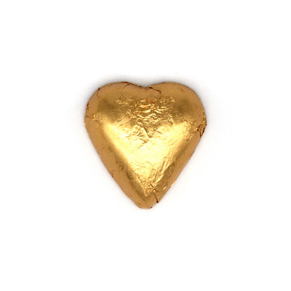 A single heart-shaped gold foil-wrapped chocolate, centered on a plain white background.