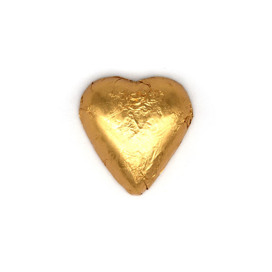 A single heart-shaped gold foil-wrapped chocolate, centered on a plain white background.